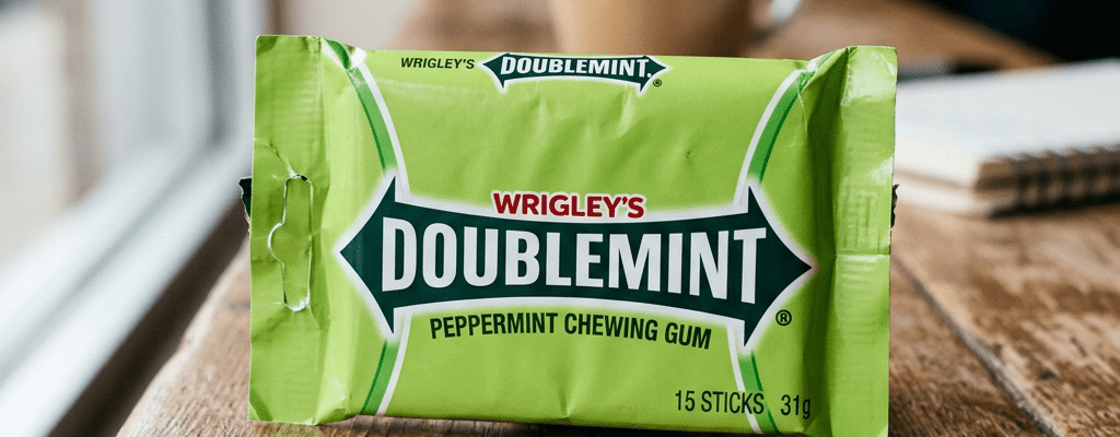 Pack of Wrigley's Doublemint peppermint chewing gum on wooden surface